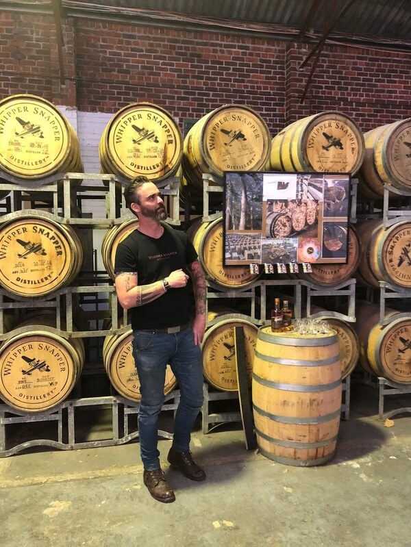 tour-guide-standing-in-front-of-whiskey-barrels-whipper-snapper-east-perth