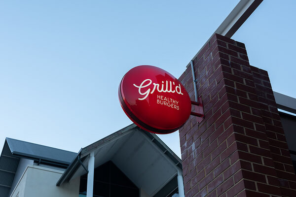 red-grilld-sign-on-building-at-sunset