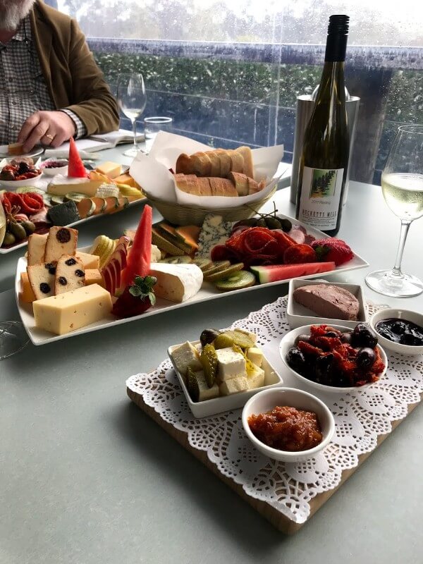 bottle-and-glass-of-late-harvest-riesling-and-platters-full-of-fruit-cheese-and-meat