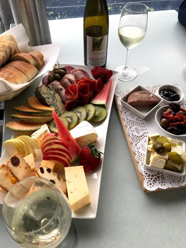 bottle-of-late-harvest-riesling-and-platters-full-of-fruit-cheese-and-meat