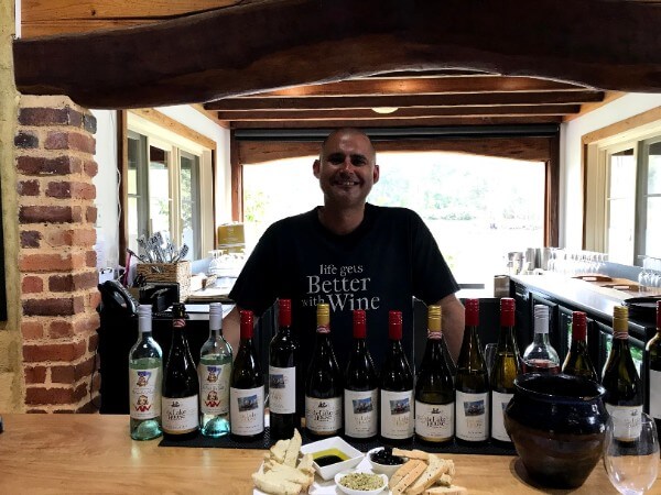 cellar-door-staff-at-the-lake-house-standing-behind-the-selection-of-wines