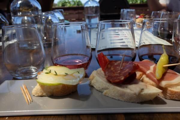 close-up-of-a-rectangle-plate-with-three-pintxos-matched-with-three-wines-with-toothpicks-on-a-wooden-table-at-pandemonium-wine-estate-swan-valley