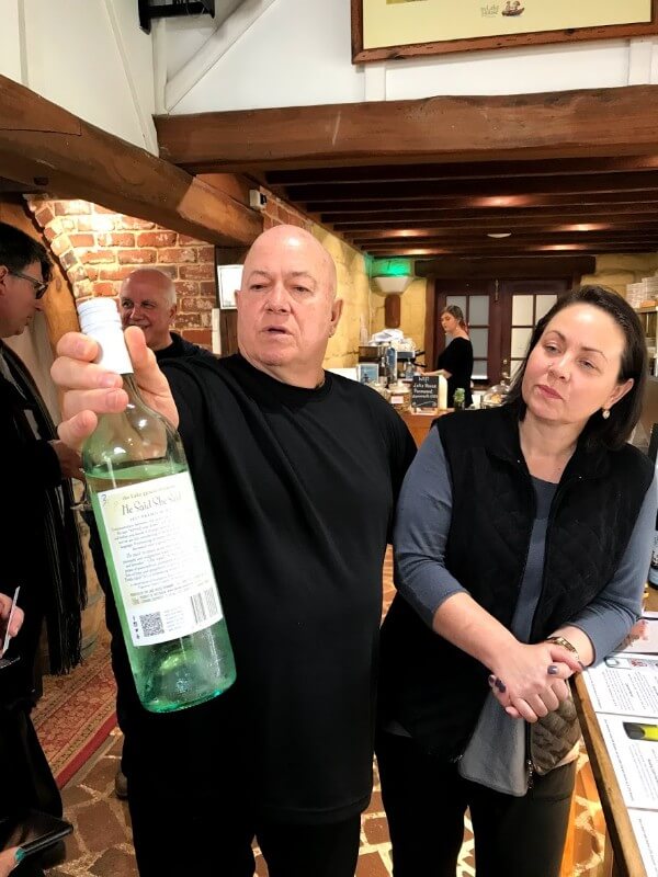 garry-holding-a-bottle-of-lake-house-wine-and-standing-next-to-leanne