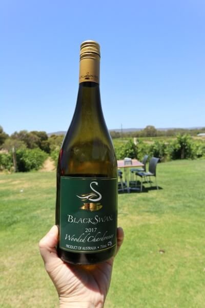 hand-holding-a-bottle-of-wooded-chardonnay-at-black-swan-winery-swan-valley