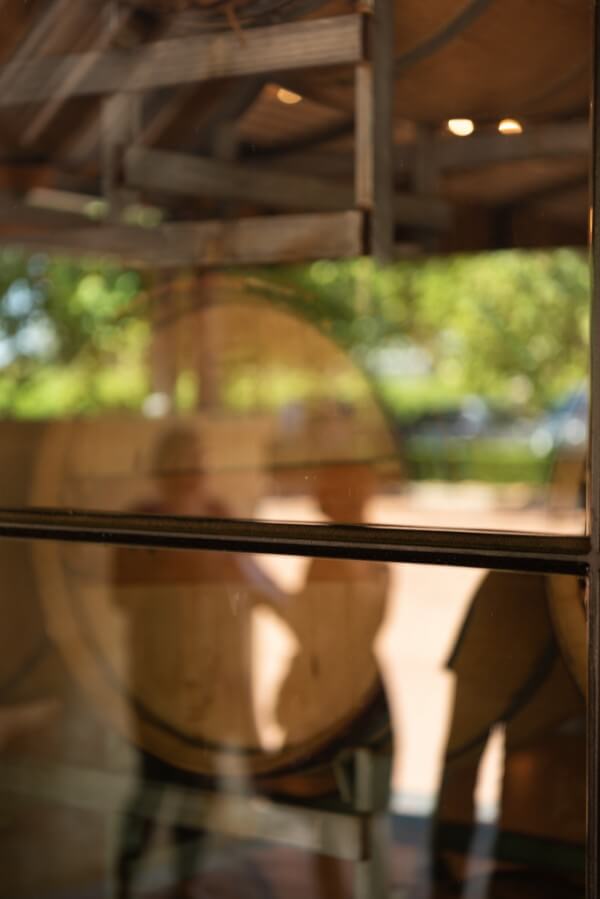 reflections-in-the-window-of-three-people-at-sandalford-winery-swan-valley