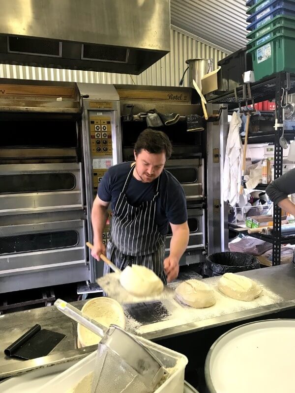 sam-dawson-prepping-the-bread-to-go-into-the-oven