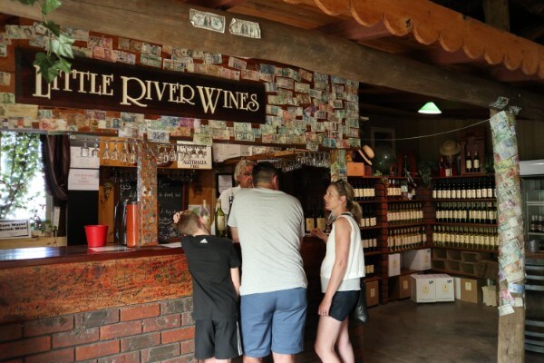three-people-standing-at-the-cellar-door-served-wines