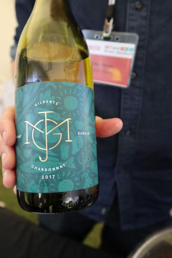 clint holding a bottle of the gilberts jmg chardonnay at the albany wine and food festival