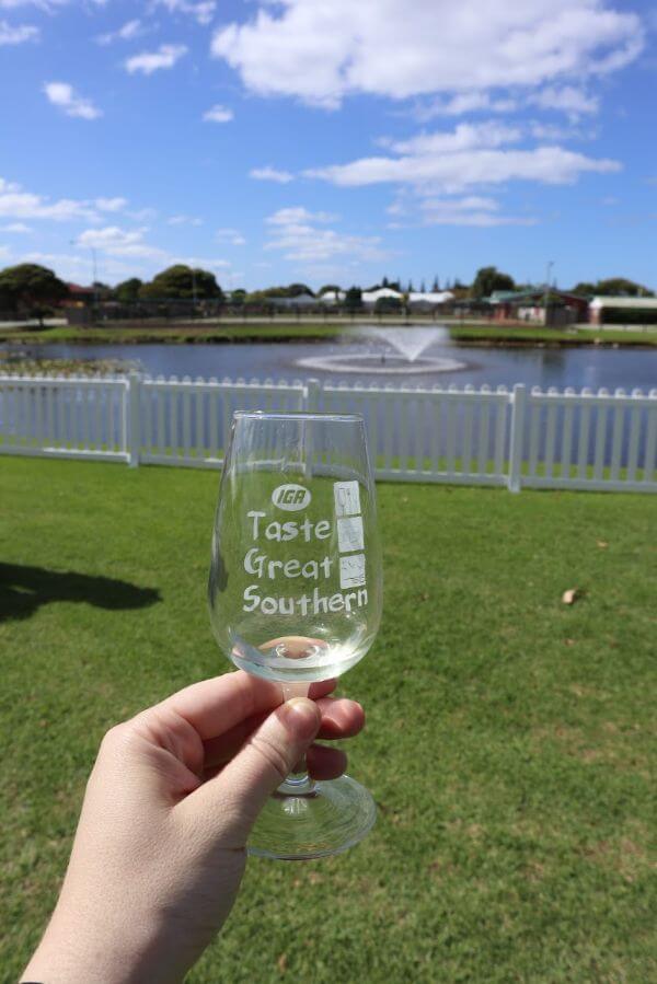 taste great southern wine glass in front of eyre park lake at the albany wine and food festival