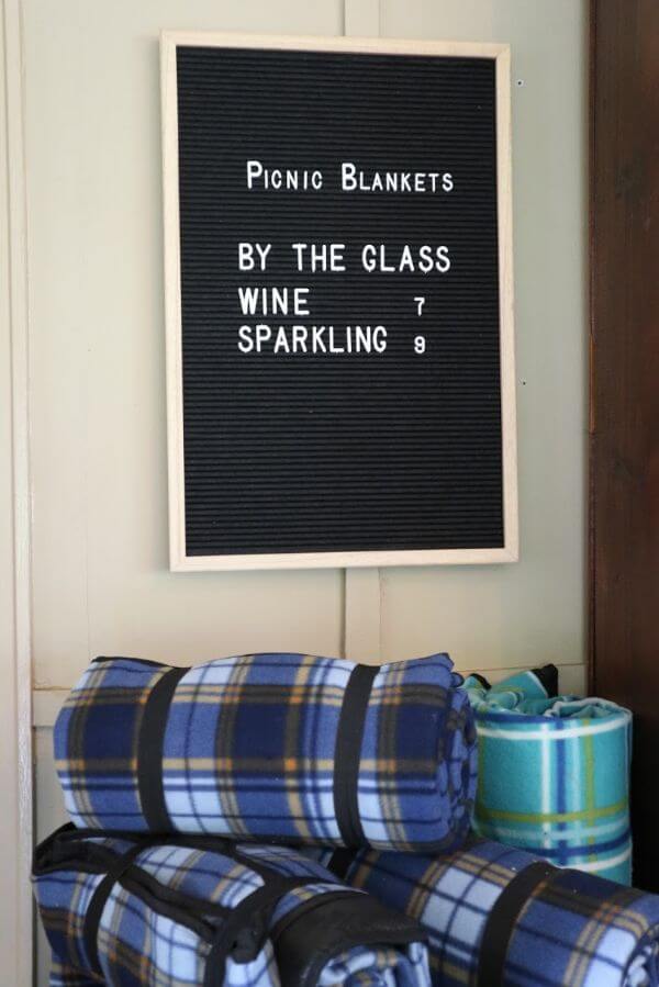 black board with picnic blankets avilable when drinking by the glass