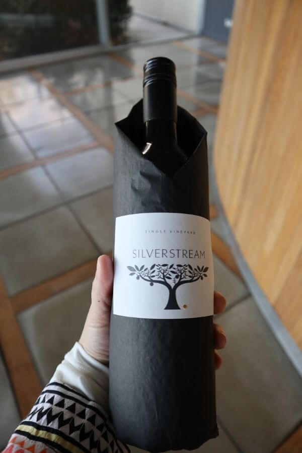 bottle of merlot wrapped up in black tissue paper silverstream wines cellar door on scotsdale road denmark wine region