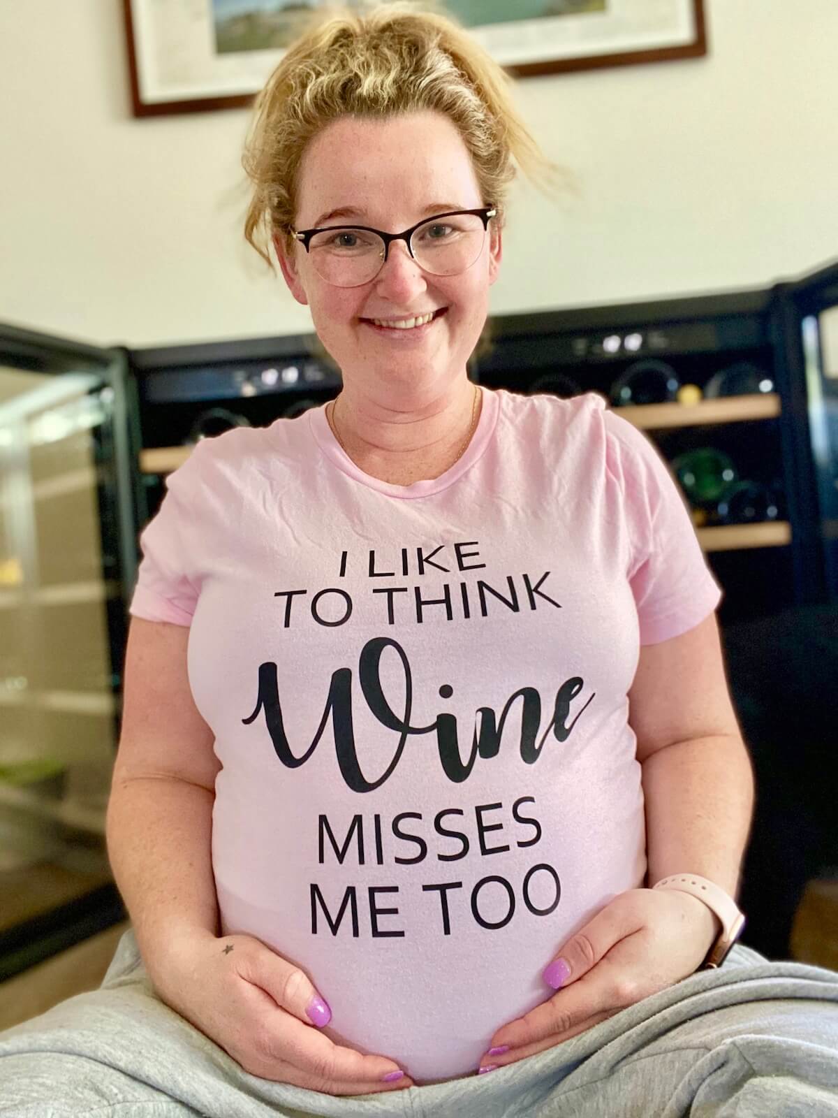 Casey in a i like to think wine misses me t-shirt sitting down
