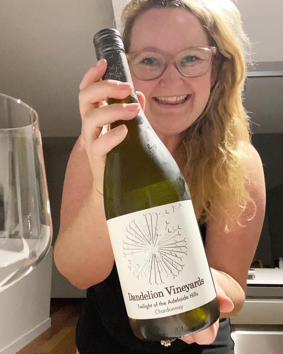 Wine Blogger Casey Holding a Bottle of Dandelion Vineyards Chardonnay