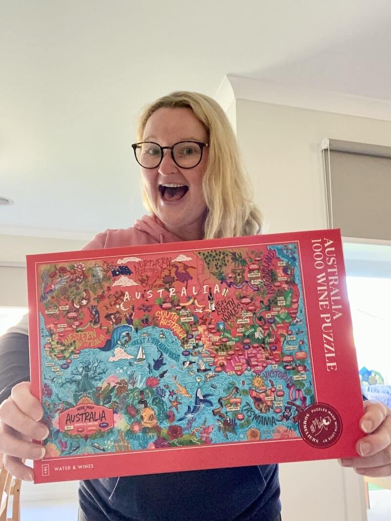 Casey holding Waters and Wine Australia Wine Map Puzzle