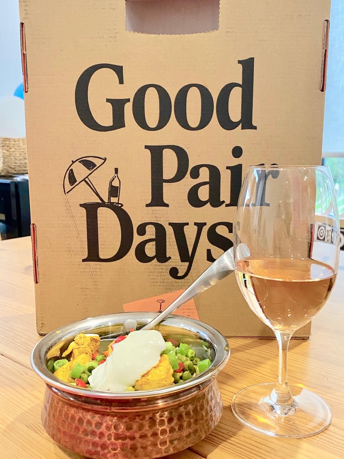 Good Pair Days wine subscription box and glass of rose wine