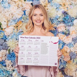 Lady with blonde hair holding Printable Wine Days 2022 Calendar