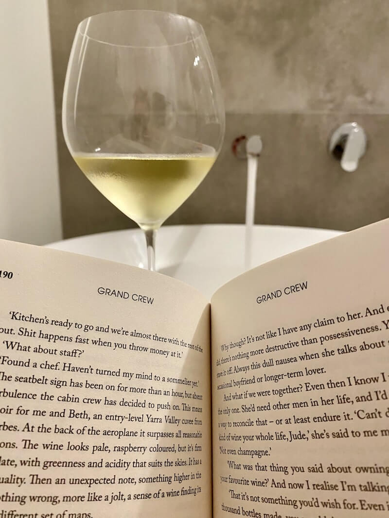 Grand Crew wine fiction book with glass of wine in bath